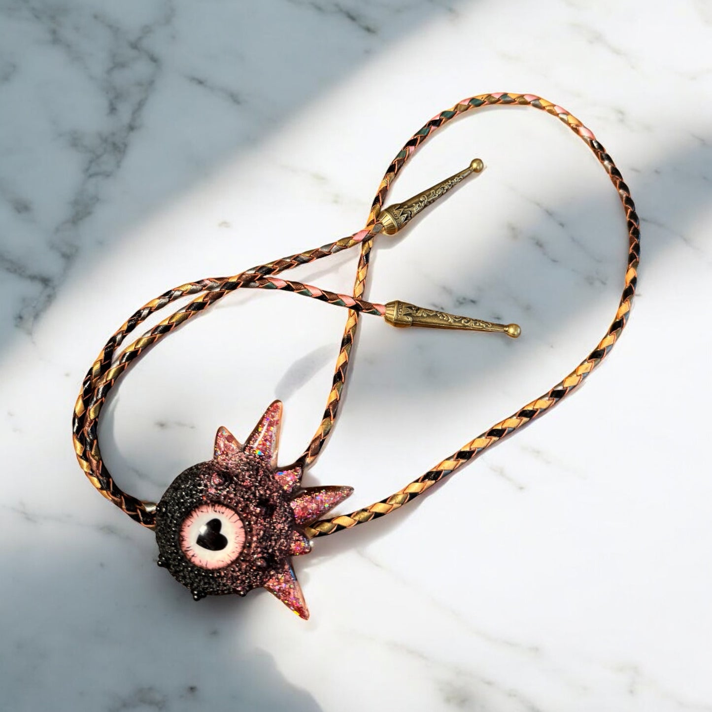 Bolo tie, black and pink monster bolo necktie. Model Spiky.
