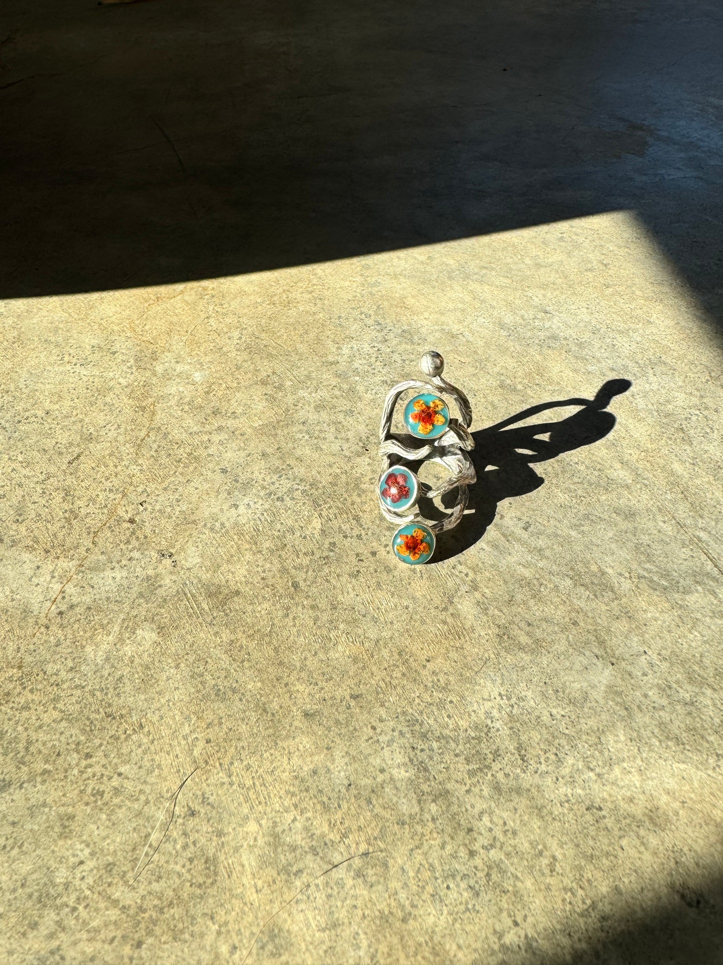 The roots ring with three orange flowers