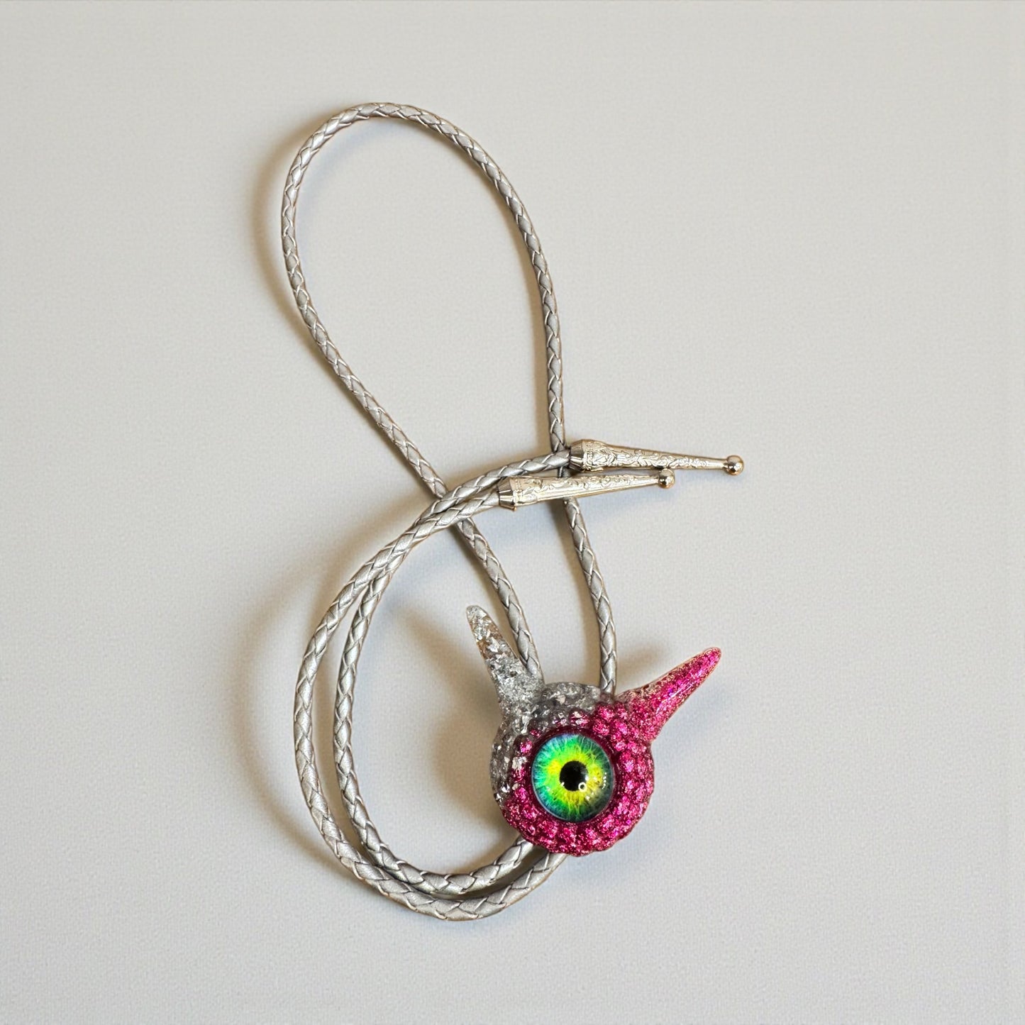 Monster bolo tie in silver and pink. Model Pointy.