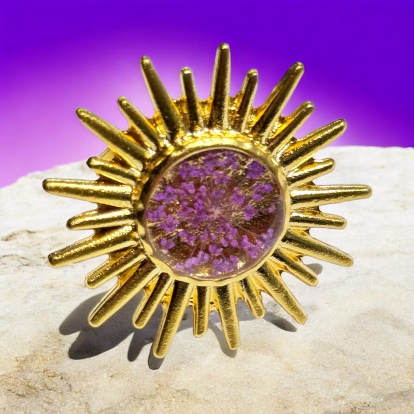 Sunburst ring with purple flower