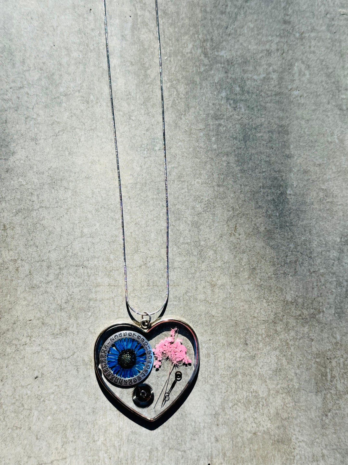 Large heart shape necklace with blue chrysanthemum and watch gear