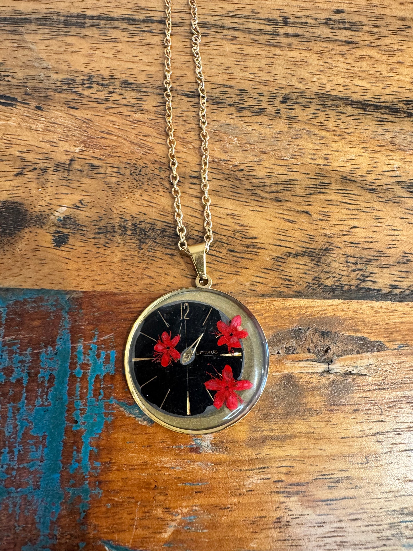 Round necklace with red flowers and watch parts