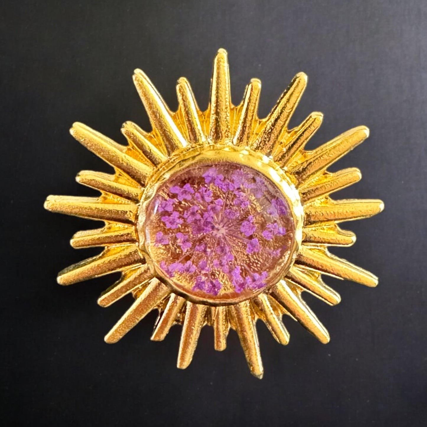 Sunburst ring with purple flower