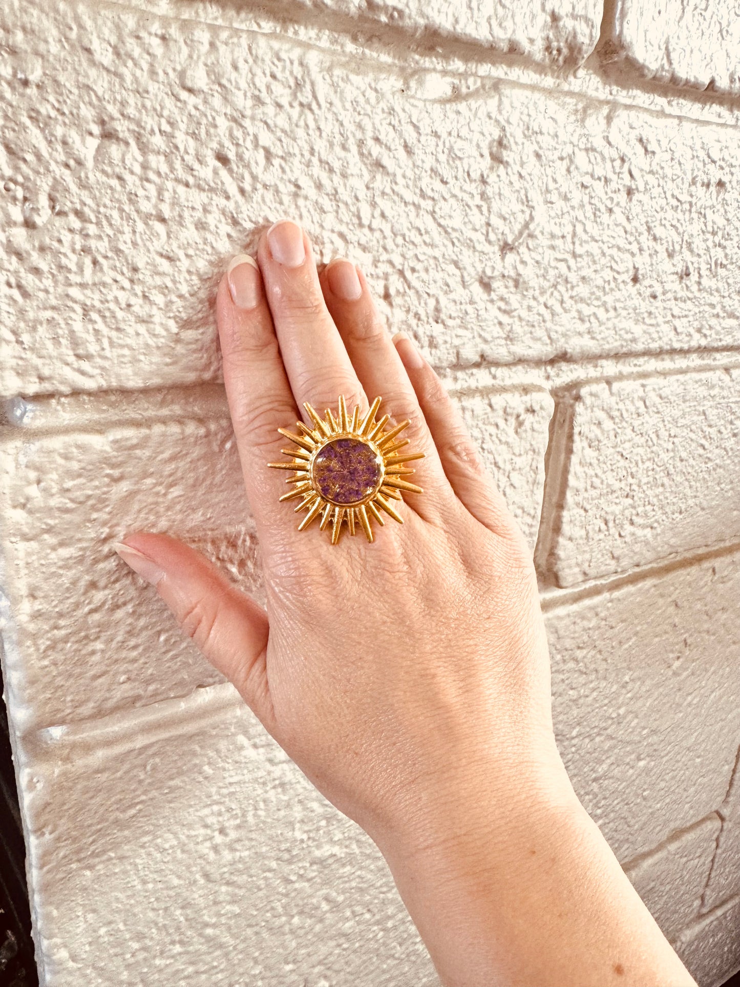 Sunburst ring with purple flower