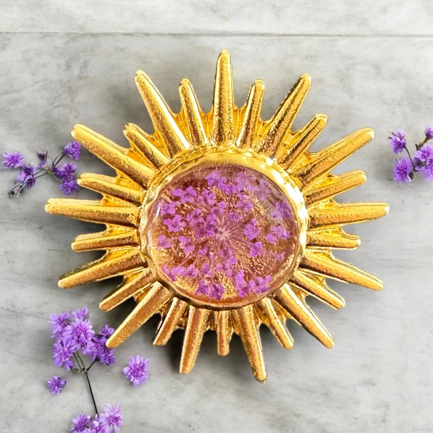 Sunburst ring with purple flower