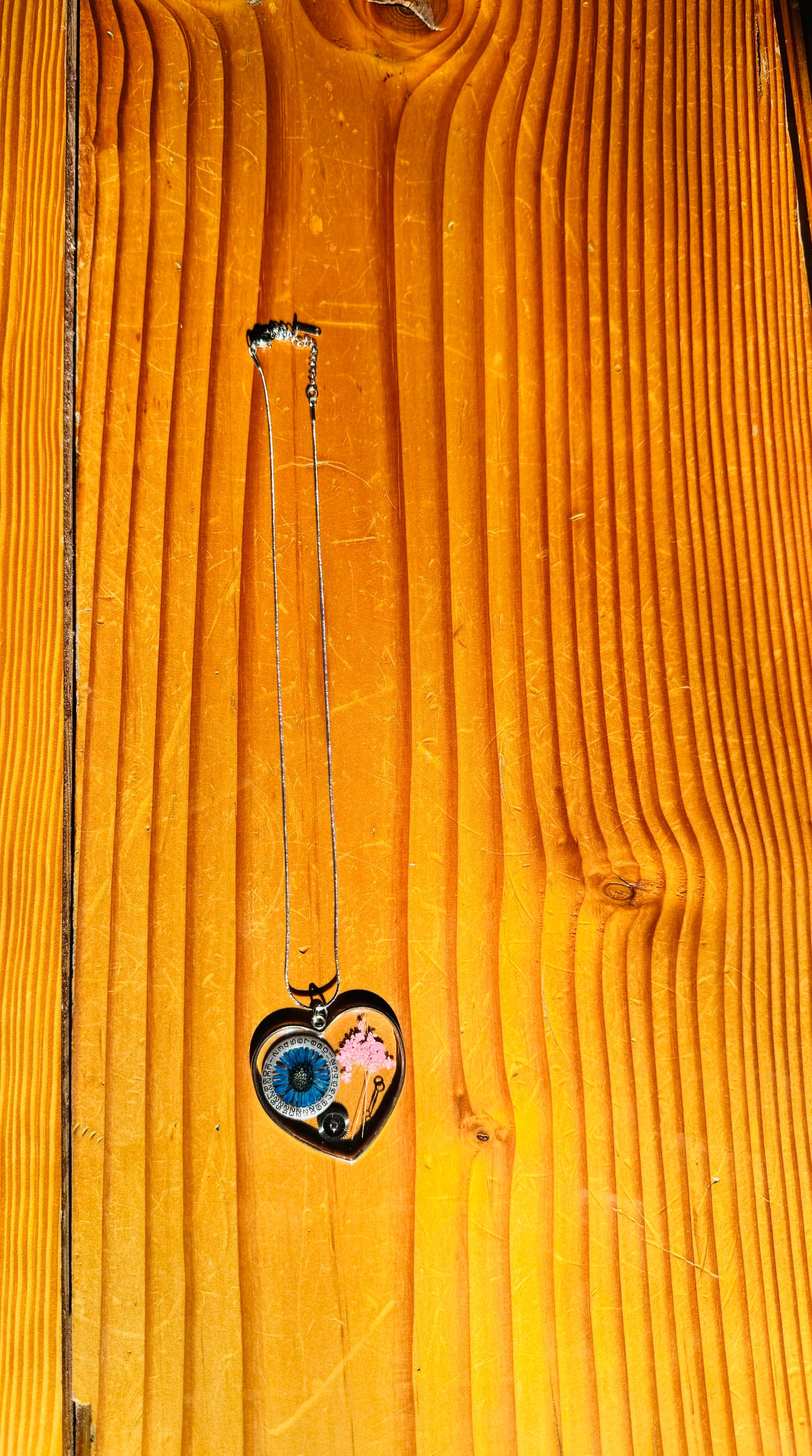 Large heart shape necklace with blue chrysanthemum and watch gear