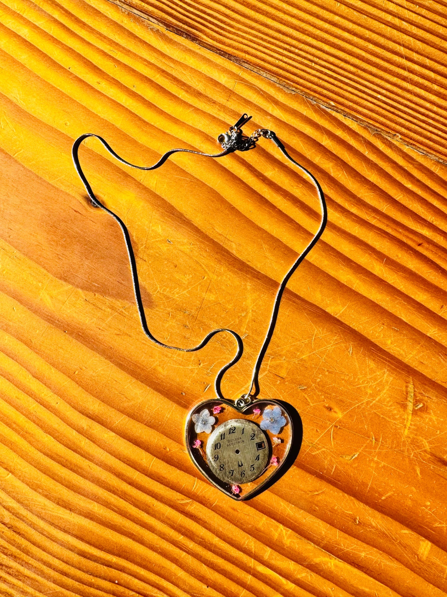 Large heart shape necklace with pressed flowers and watch gear