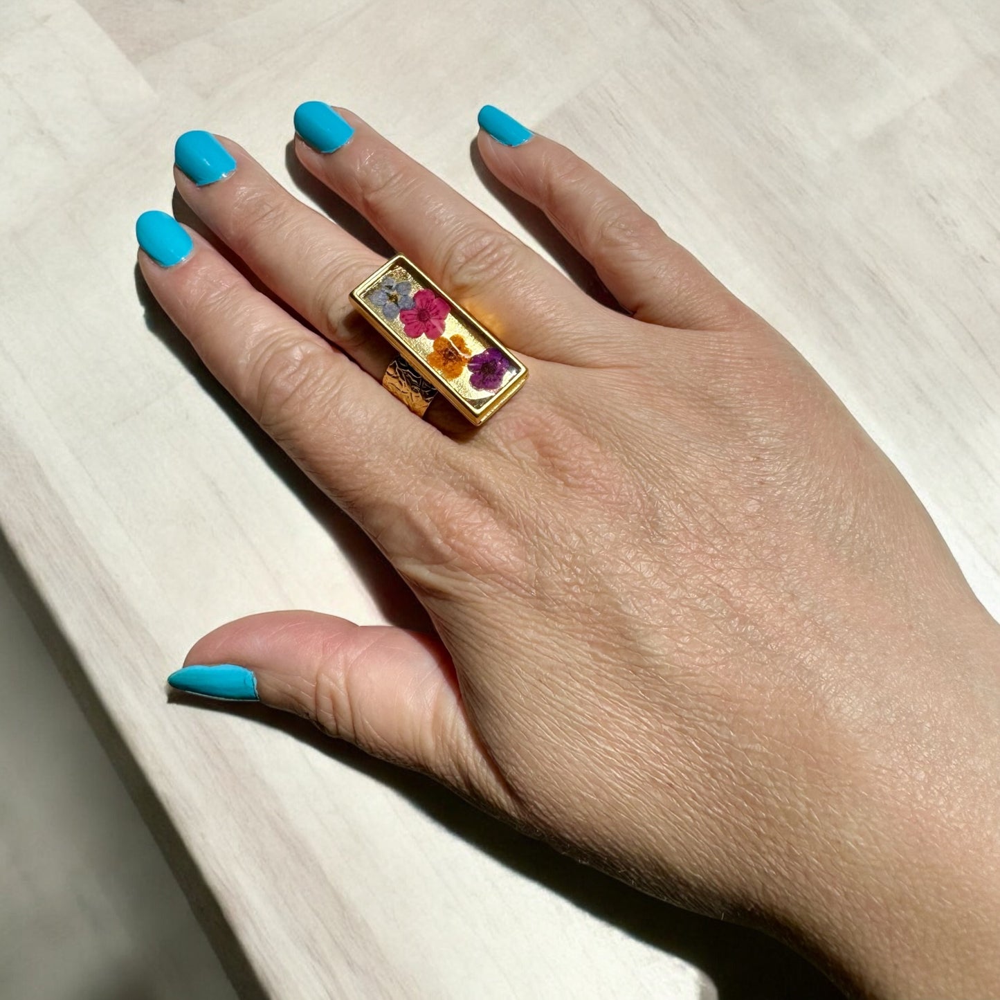 Rectangular gold plated ring with 4 flowers