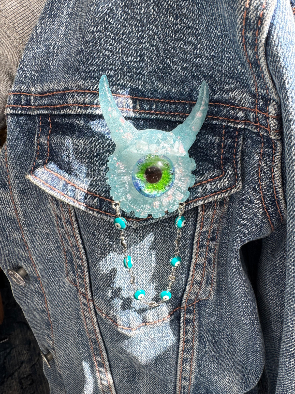 09/05 Monster brooch with chain. Model Vicky.