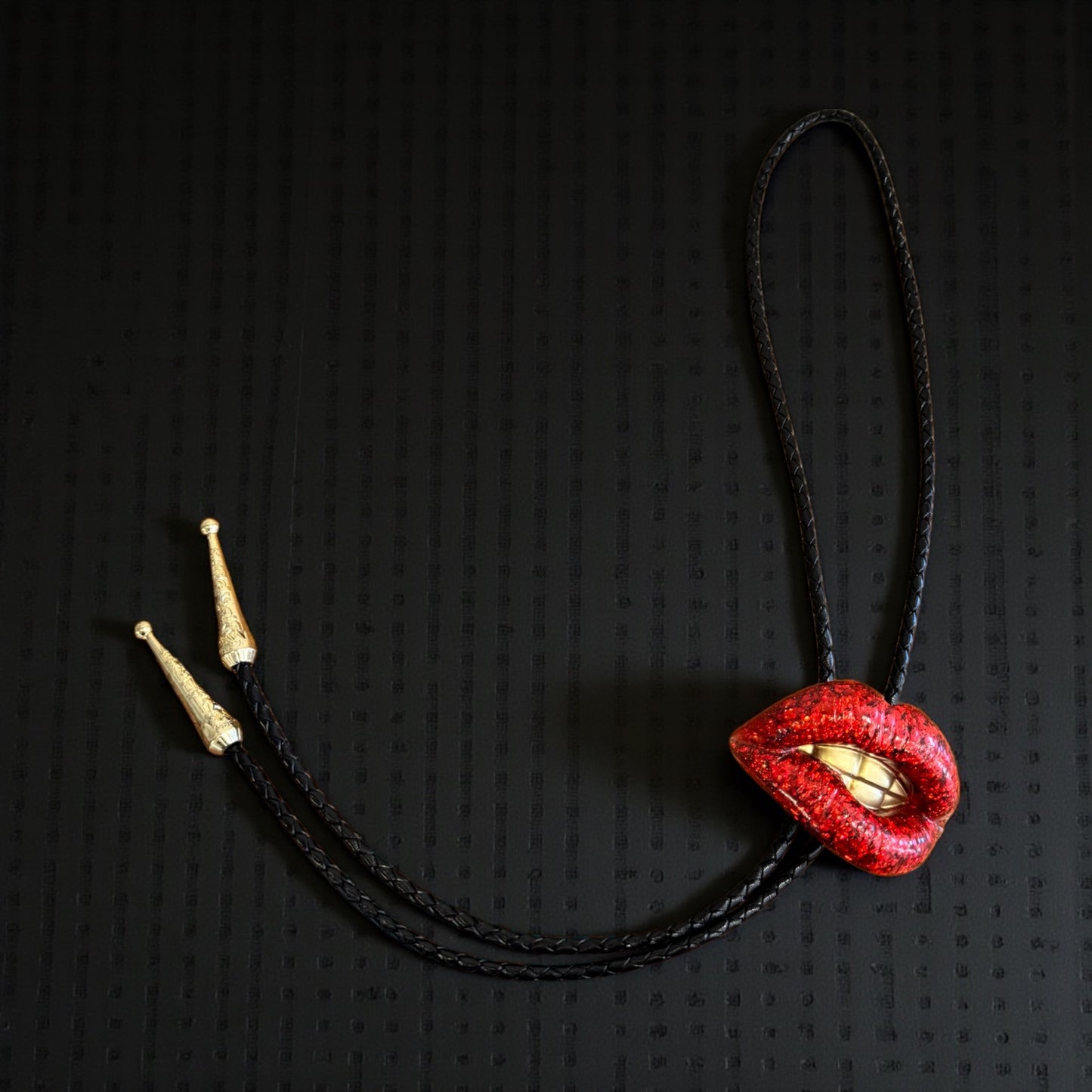 Bolo tie, sparkly red lips with gold teeth