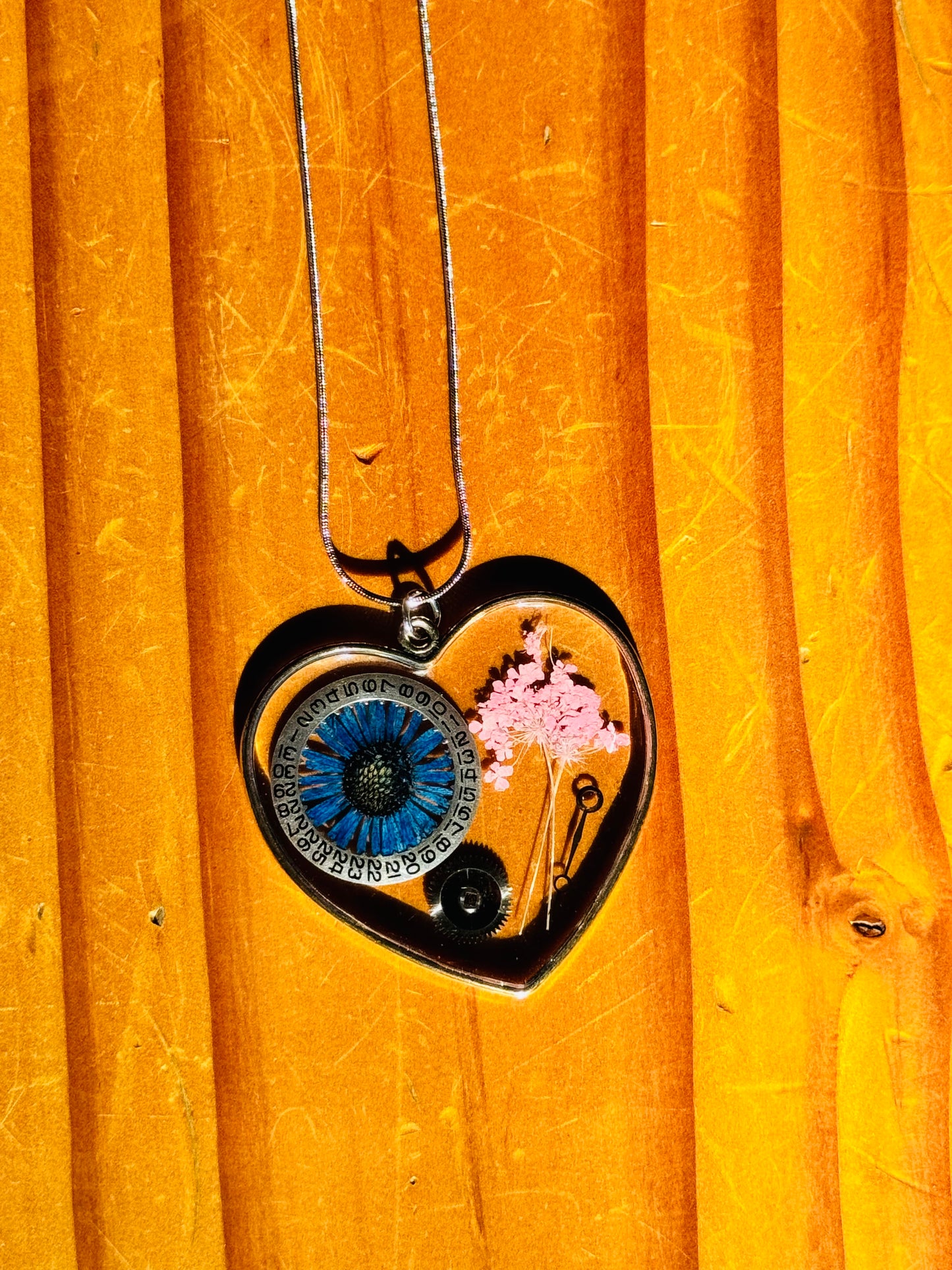 Large heart shape necklace with blue chrysanthemum and watch gear