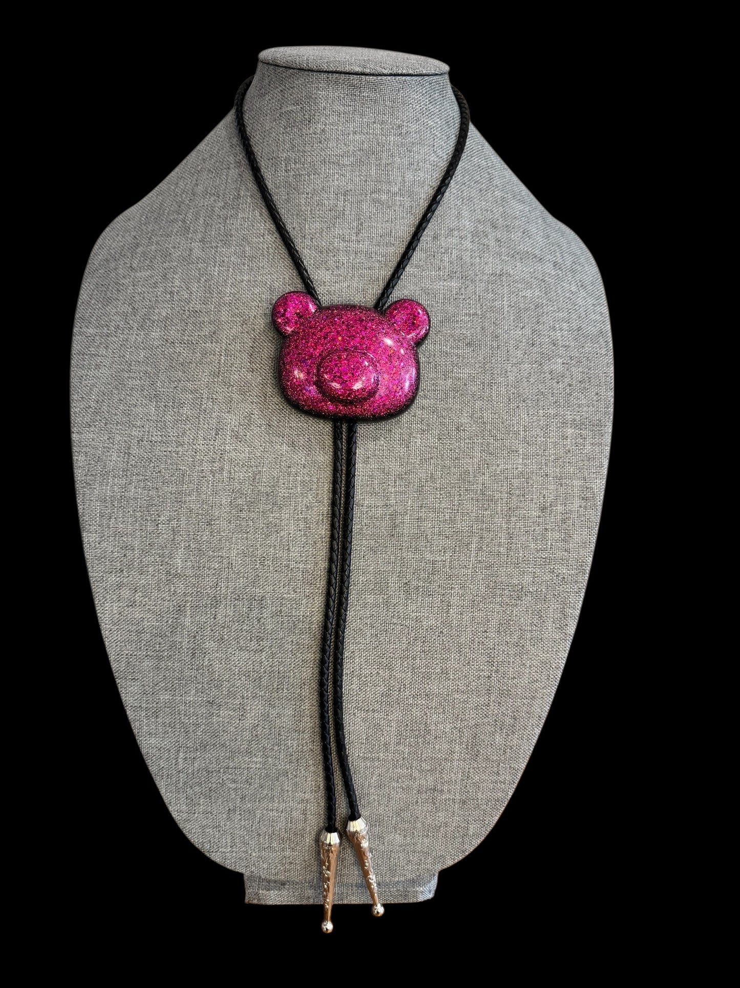 Gummy bear head bolo tie in pink and black.