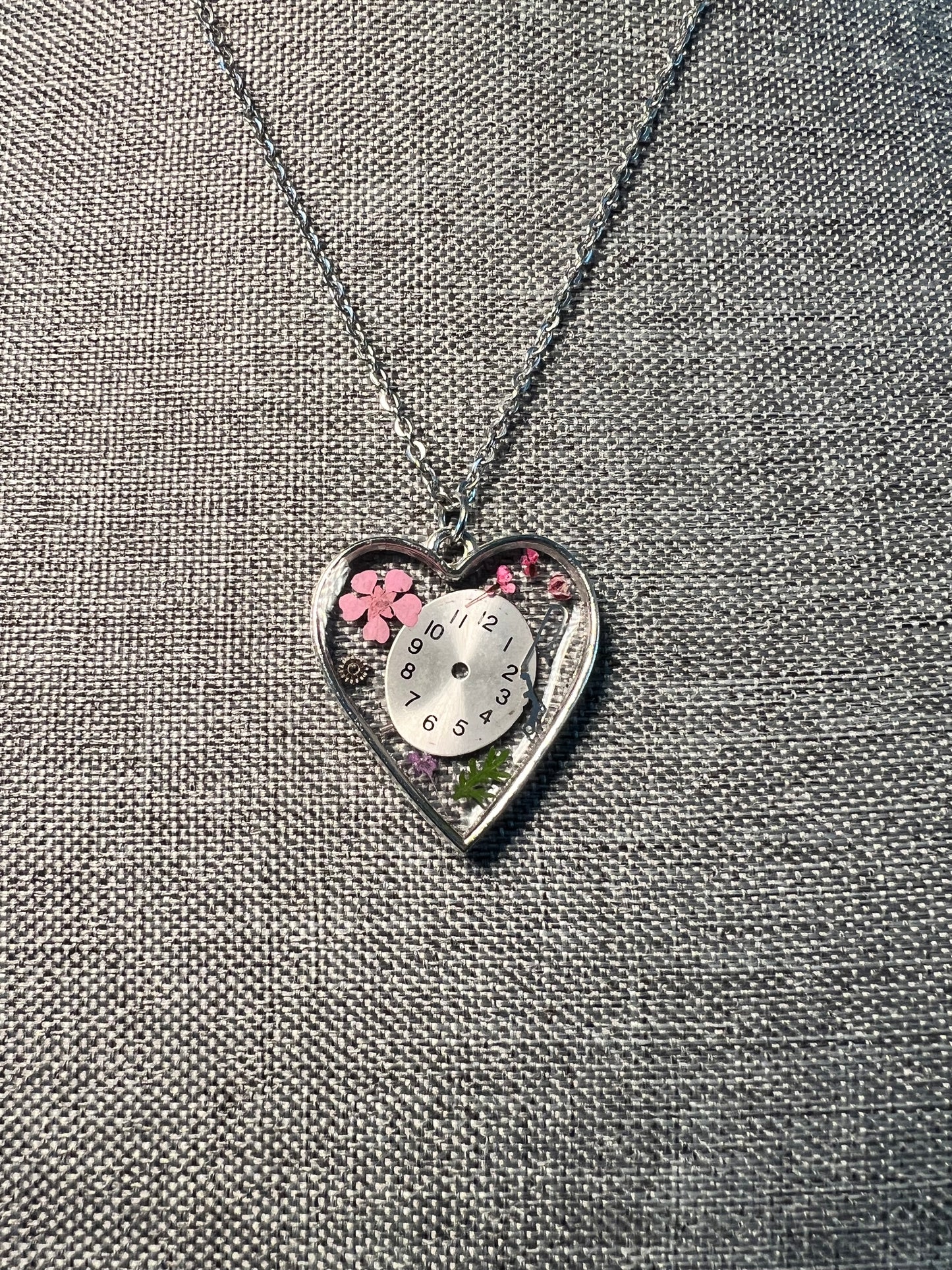 Heart necklace with pink flowers and watch face and gear