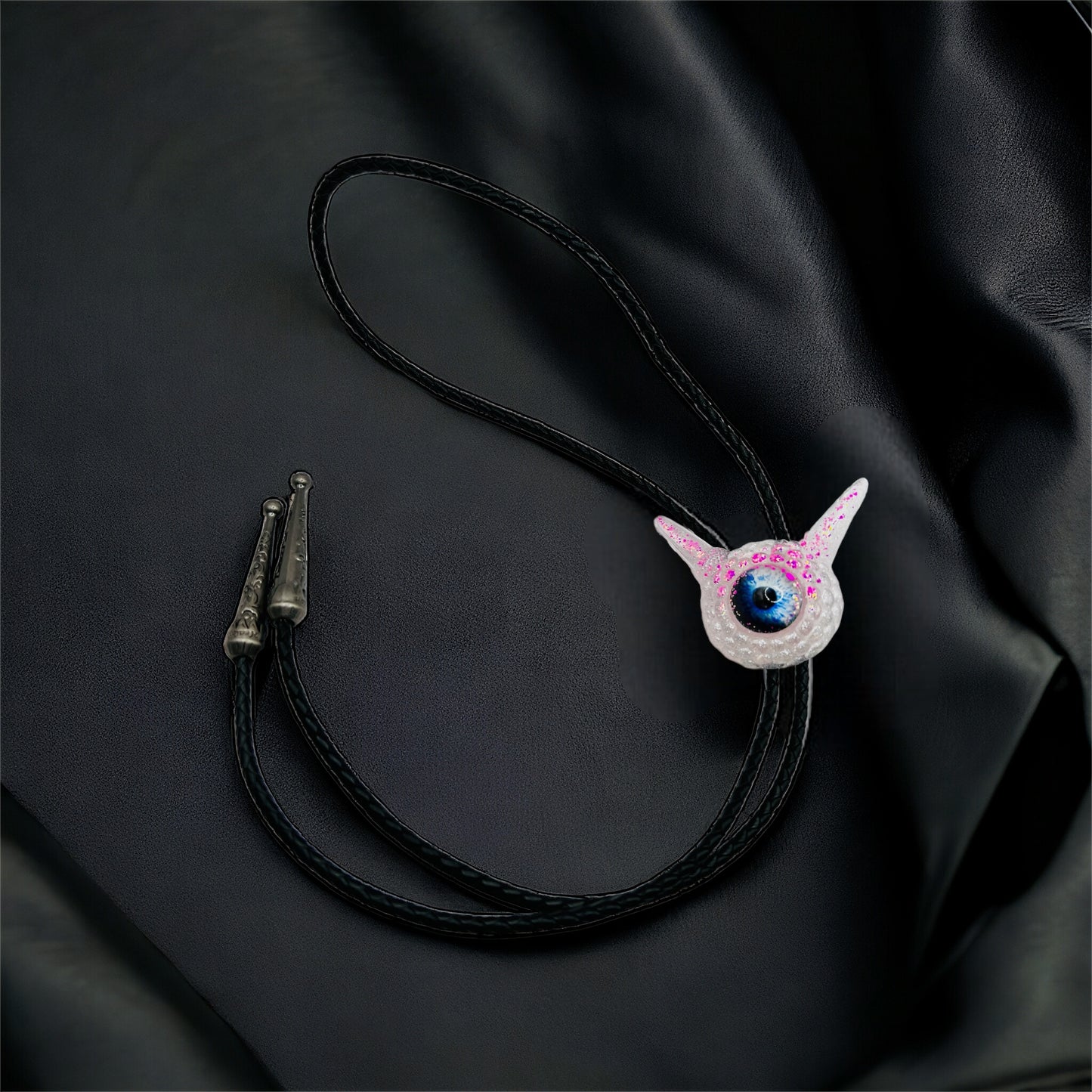 Monster bolo tie in white and pink. Model Pointy.