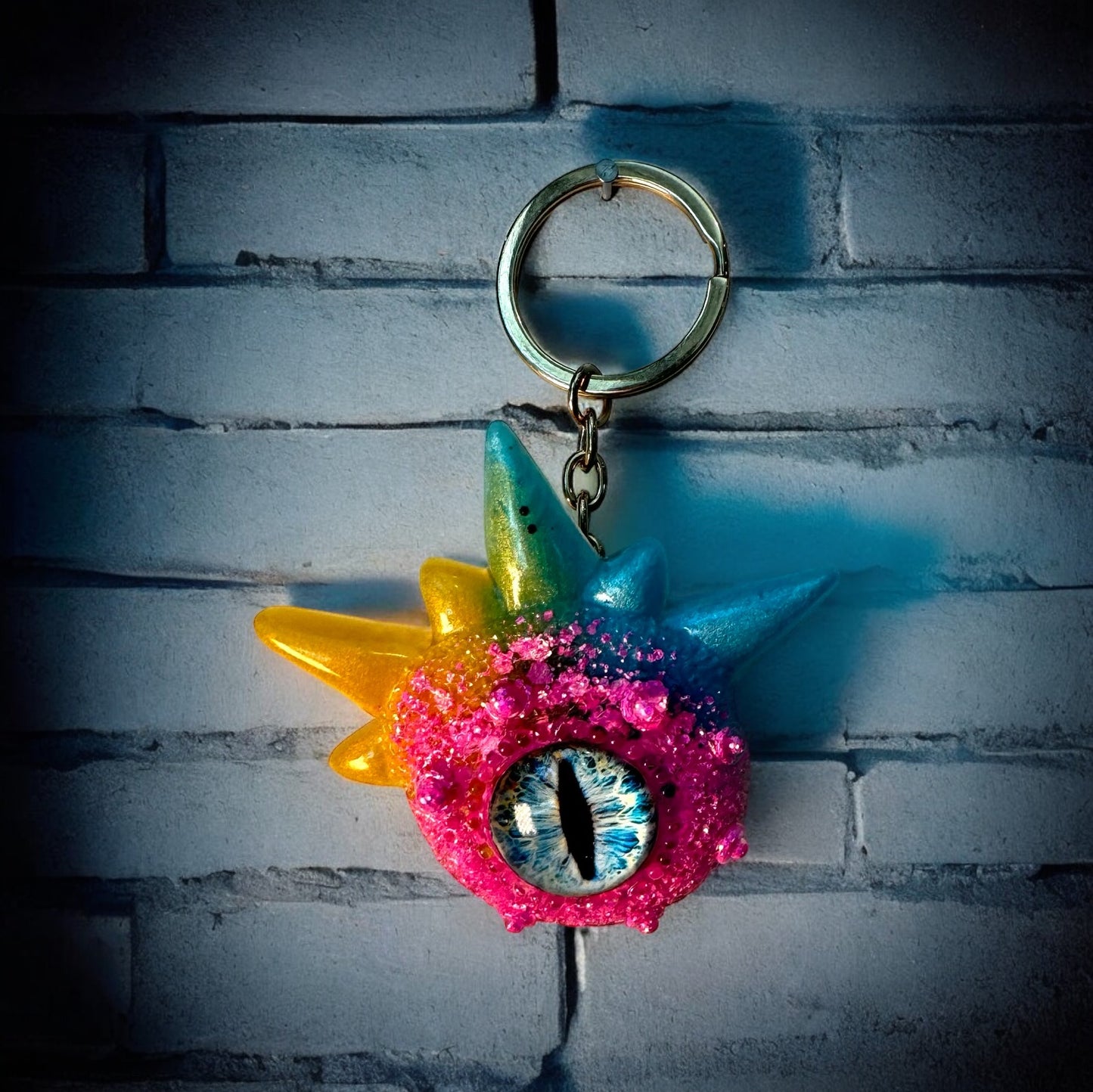 Monster keychain, pink,blue and yellow. Model Spiky.