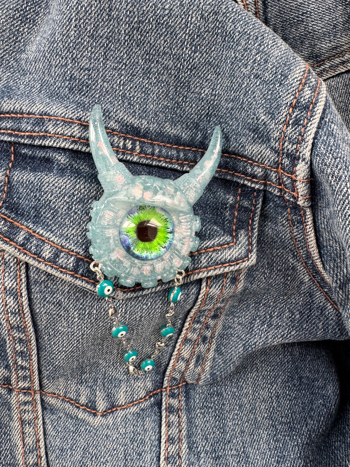 09/05 Monster brooch with chain. Model Vicky.