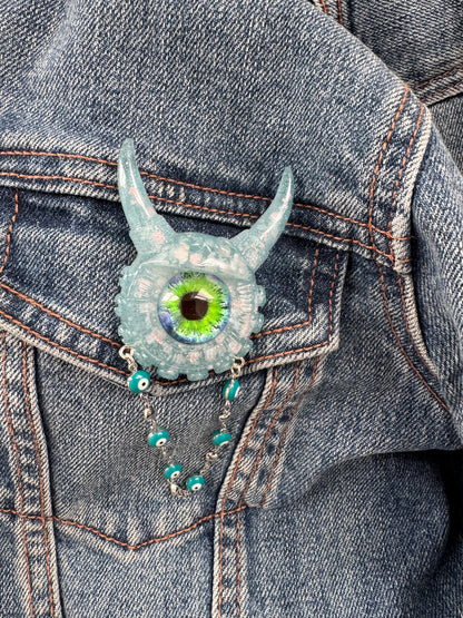 09/05 Monster brooch with chain. Model Vicky.