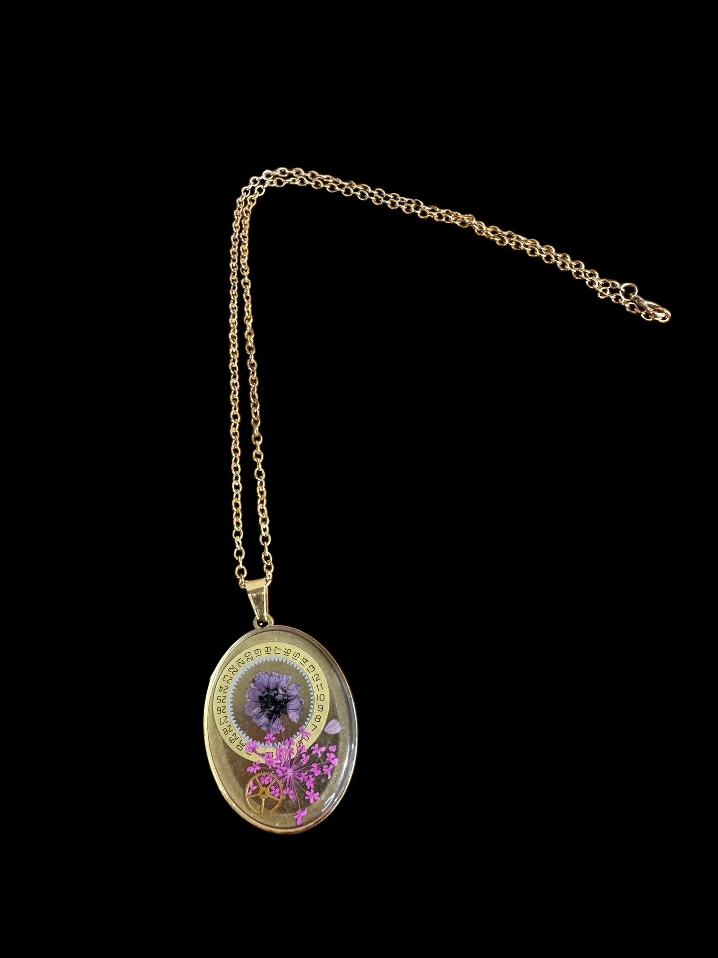 Oval necklace with purple and pink flowers and watch parts