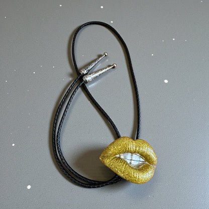 Bolo tie, gold lips and silver teeth
