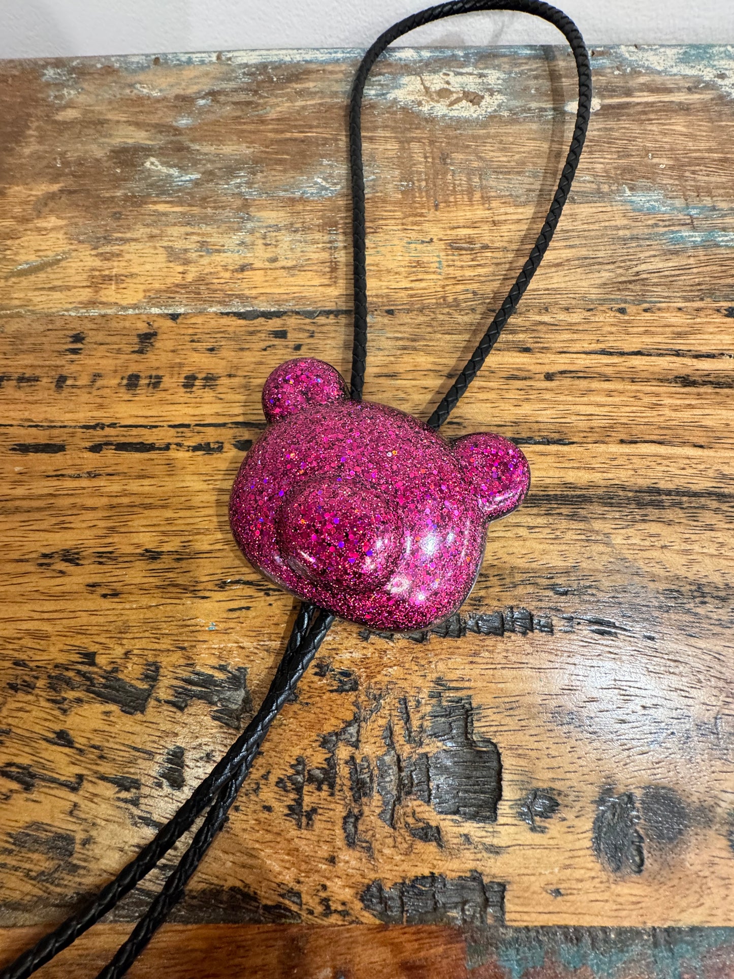 Gummy bear head bolo tie in pink and black.