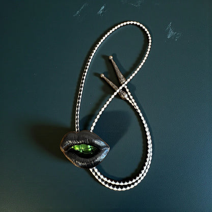 Bolo tie, black lips and green teeth