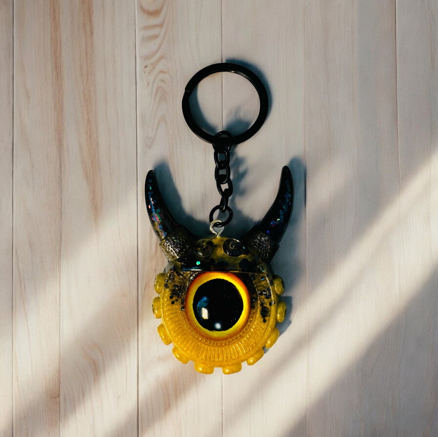 Monster keychain gold,yellow and black. Model Vicky.