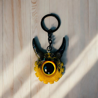 Monster keychain gold,yellow and black. Model Vicky.