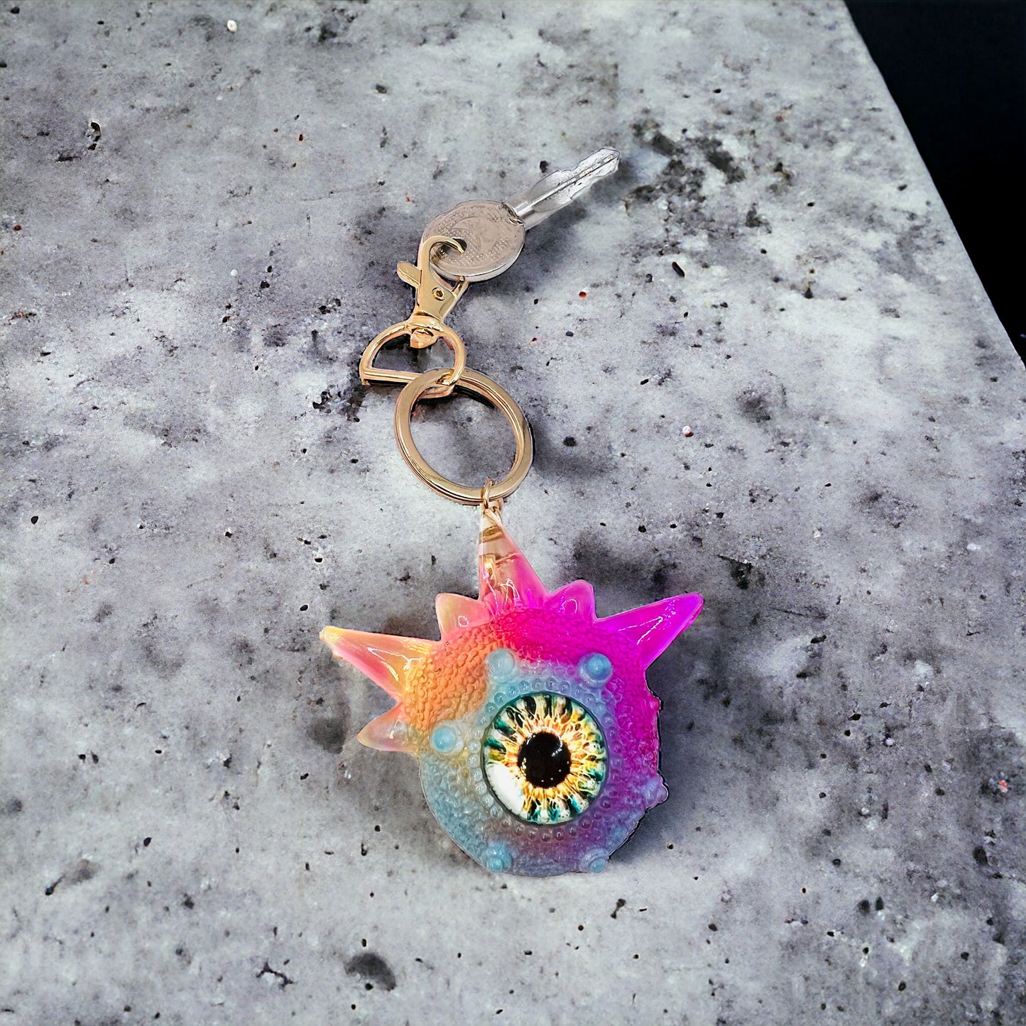 Monster keychain, pink,blue and yellow. Model Spiky.