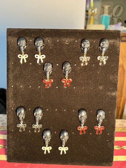 Skull with white bow and silver metal earrings studs