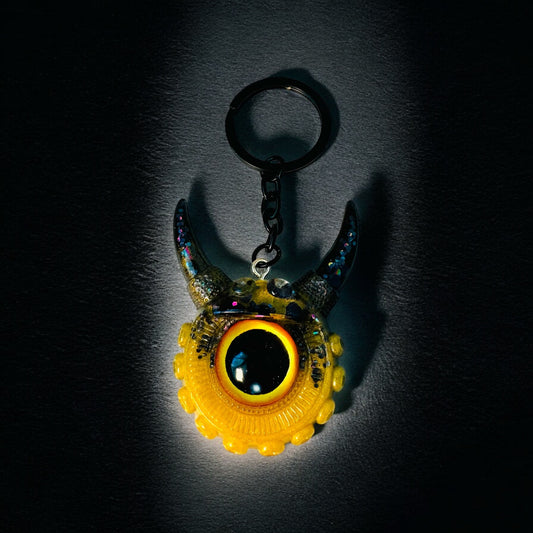 Monster keychain gold,yellow and black. Model Vicky.