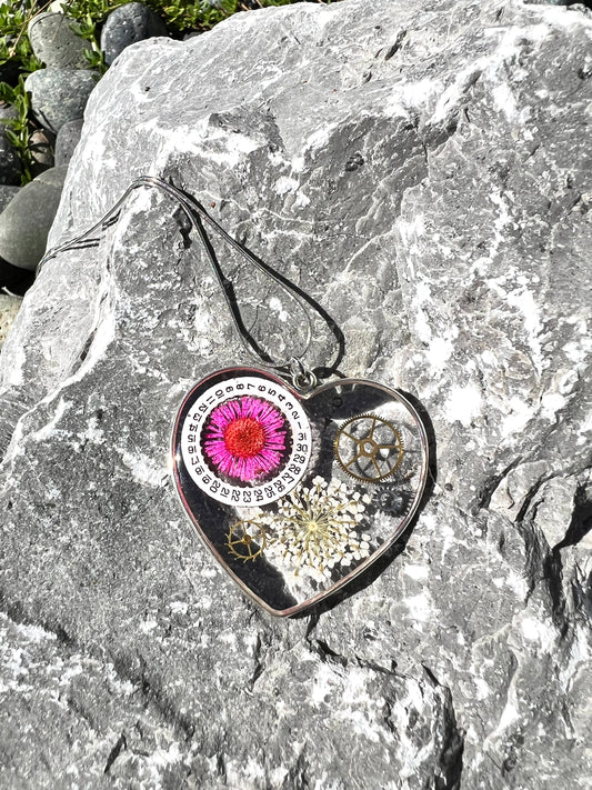 Large heart shape necklace with pink daisy, white Queen Anne lace and watch gear