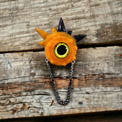 Handmade brooch, orange and black monster brooch, pastel goth jewelry, evil eye brooch in resin,creepy cute,spooky jewelry, kawaii brooch, unique brooch. Model Spiky.