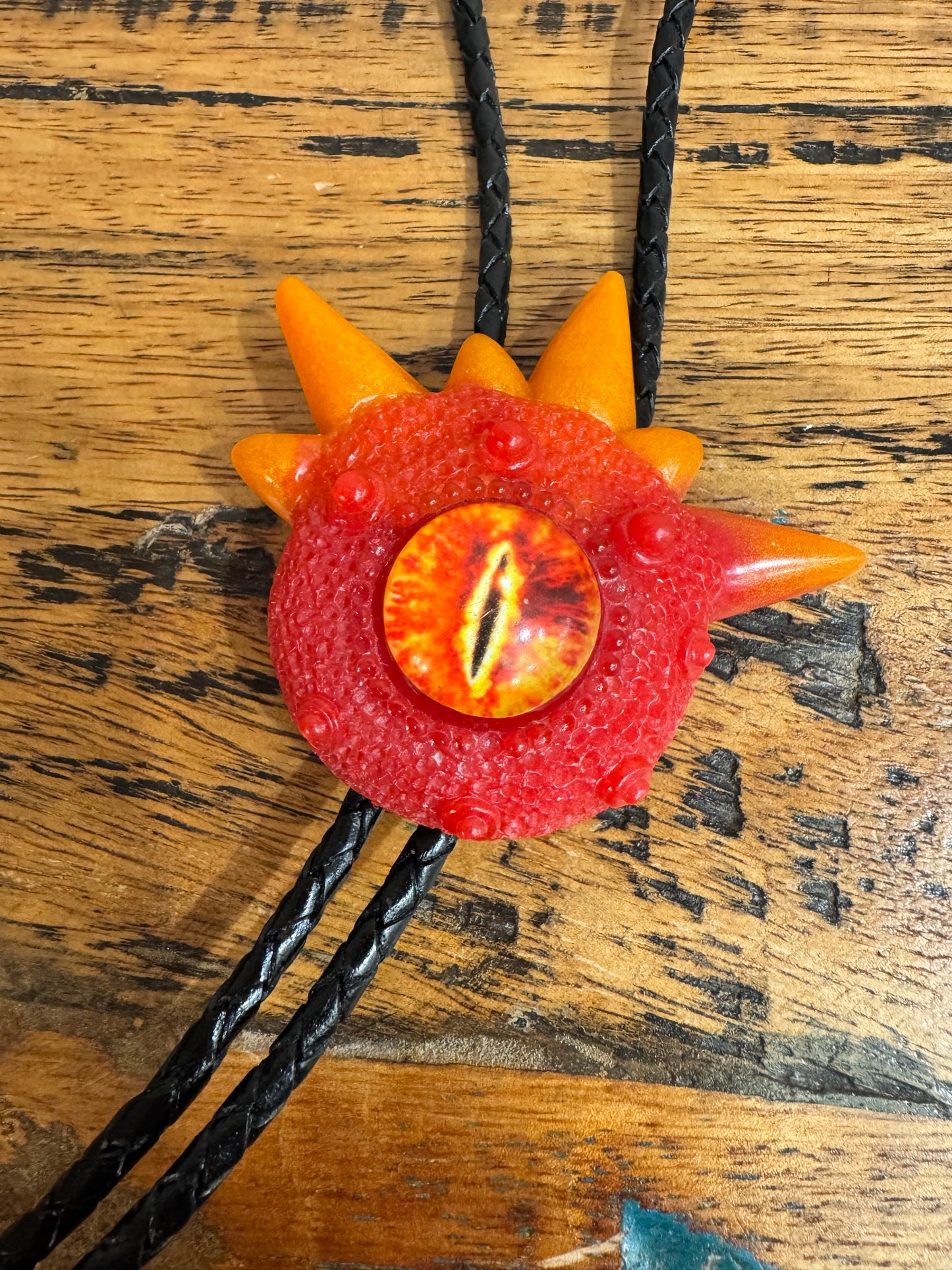 Monster bolo tie in red and orange. Model Spiky.