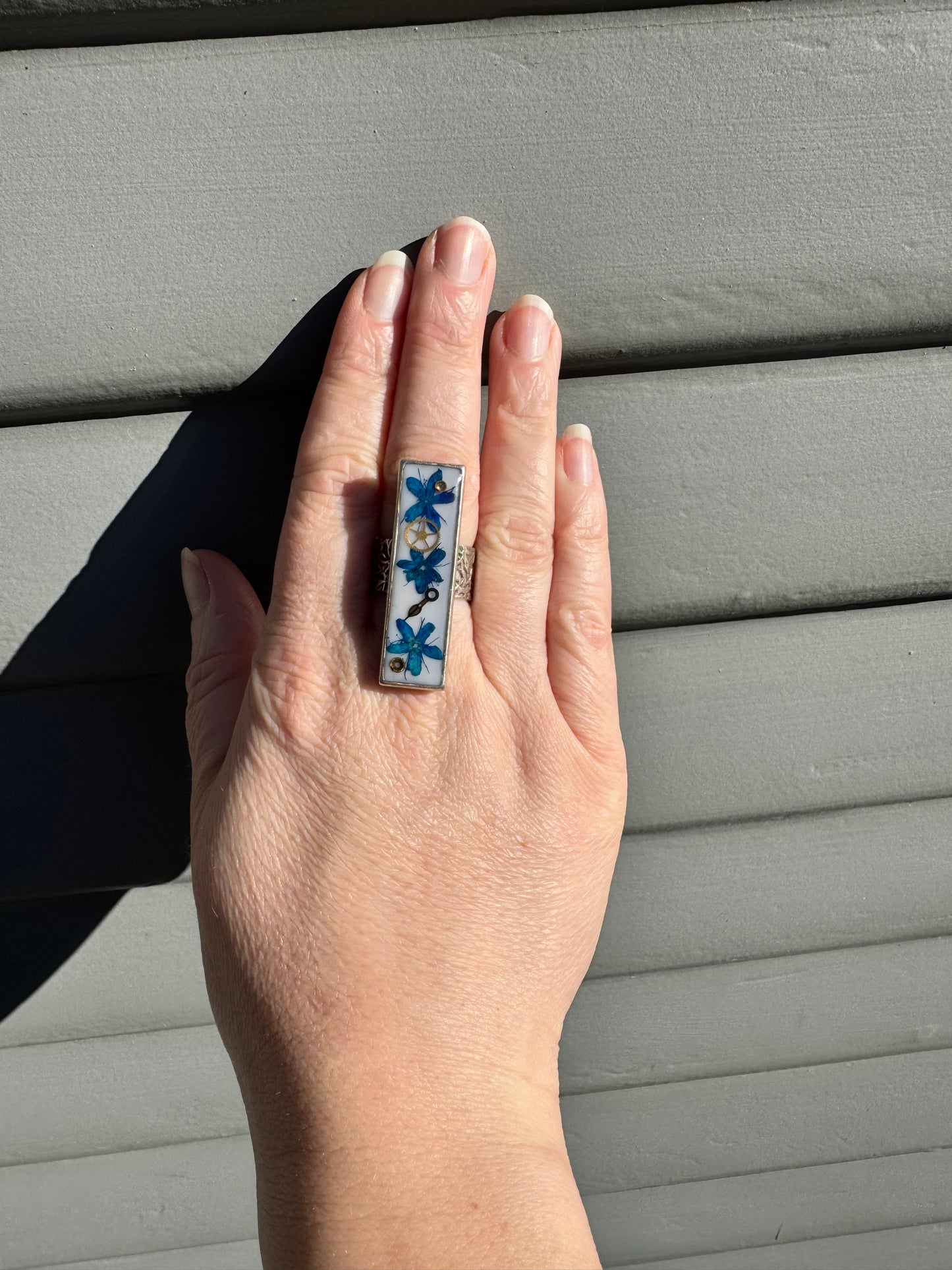 Rectangle ring with blue flowers and watch gears