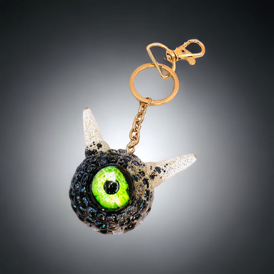 Monster black and gold kawaii keychain. Model Pointy.