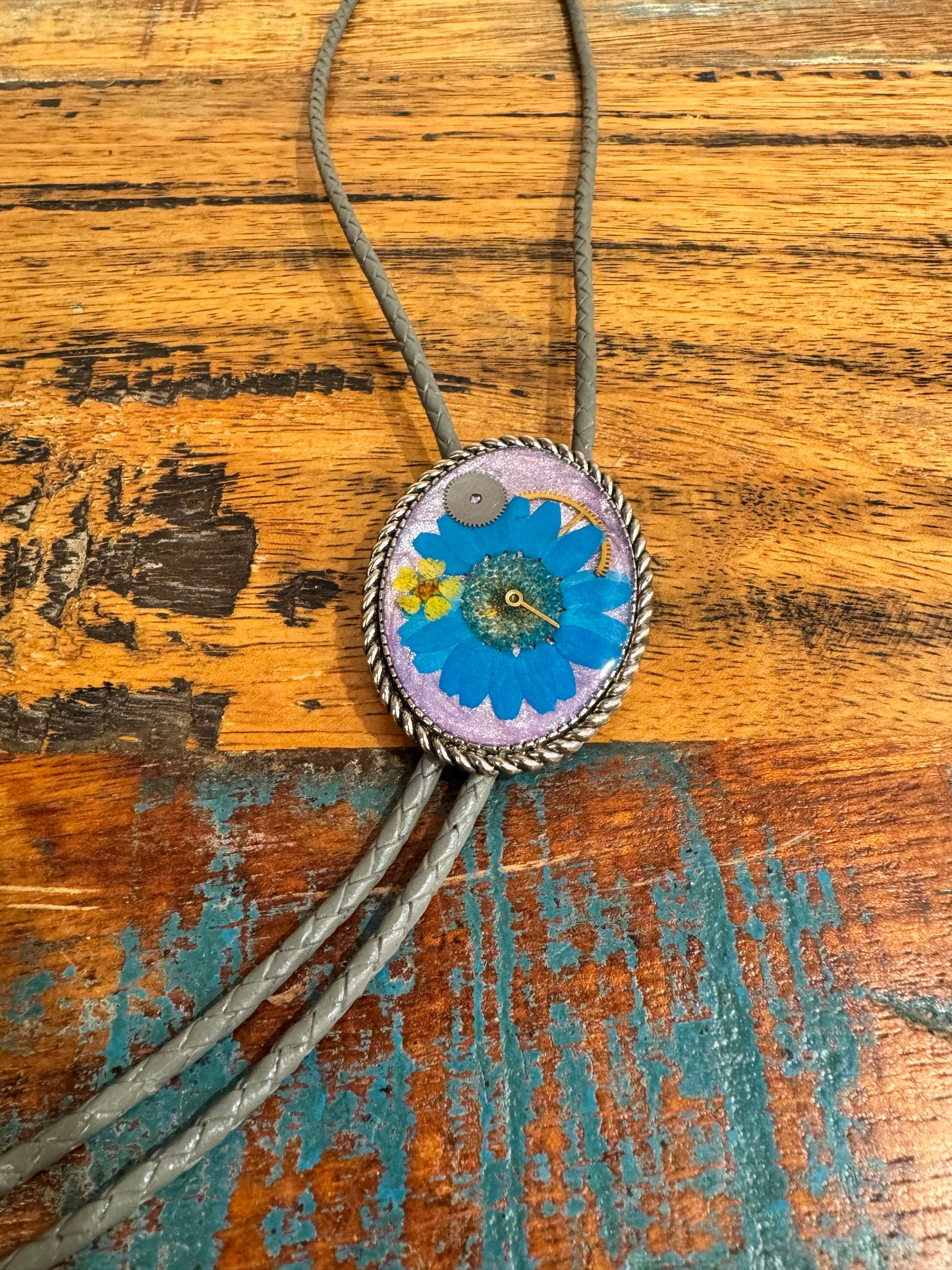 Bolo tie, blue daisy flower and watch gears