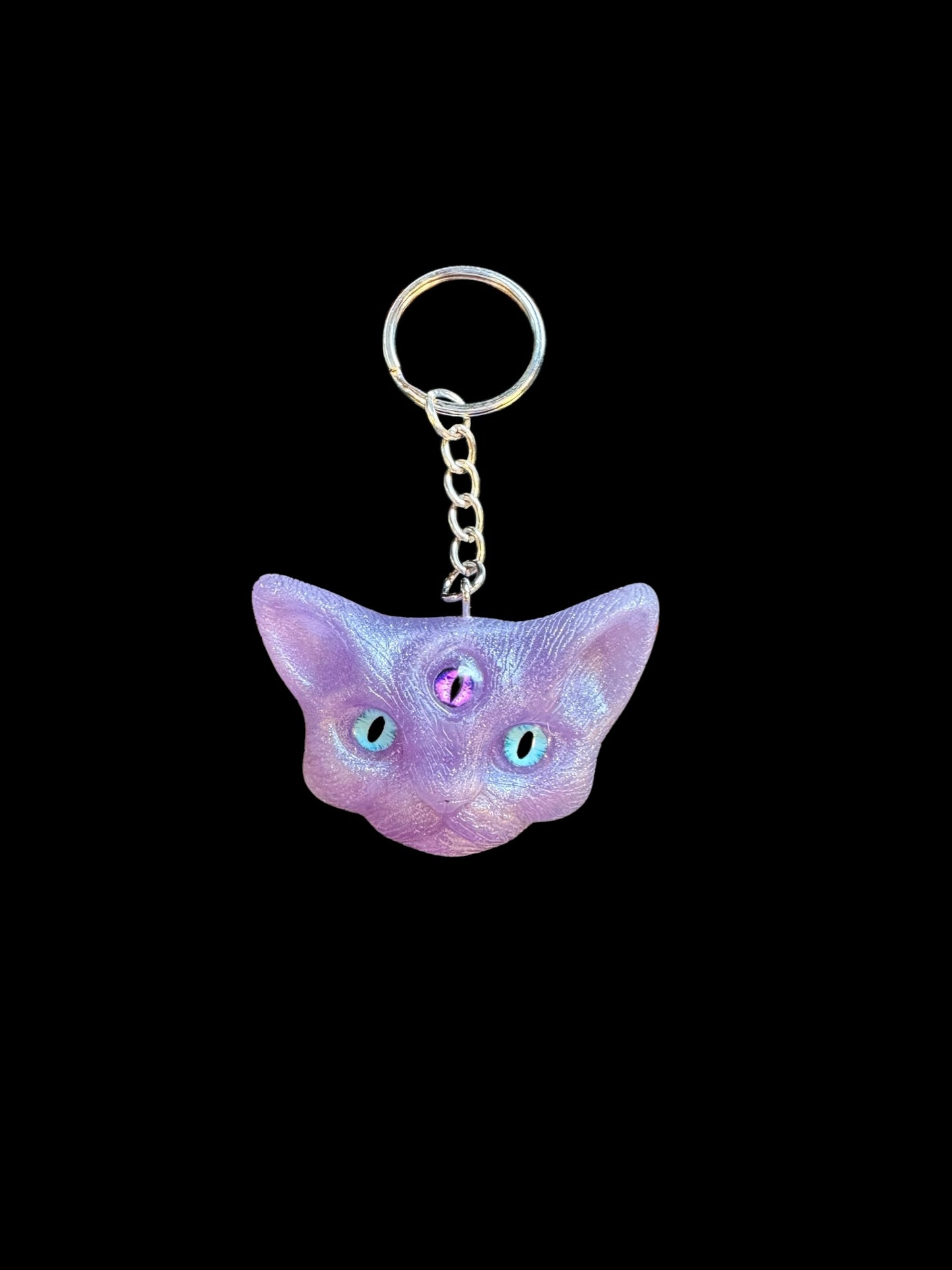 Three eyed cat keychain in purple