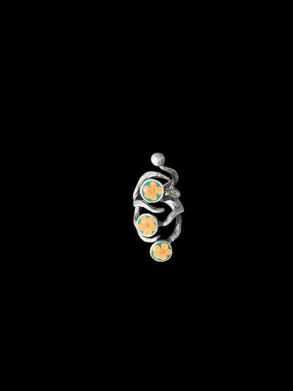 The roots ring with three orange flowers on green background