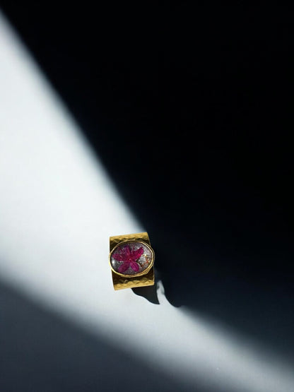 Circular gold plated ring with pink flower and star
