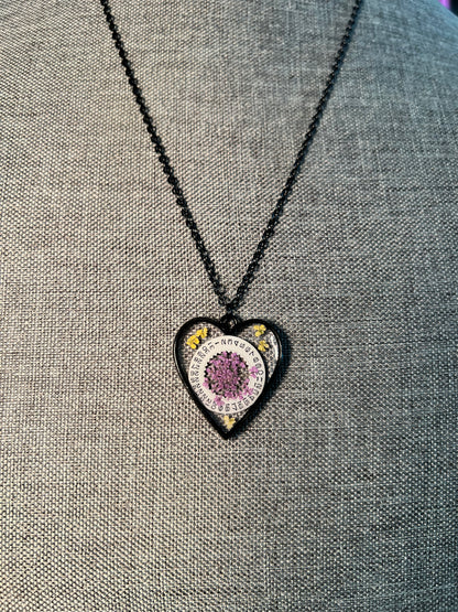 Black Heart necklace with purple and yellow Queen Anne lace flowers and watch part