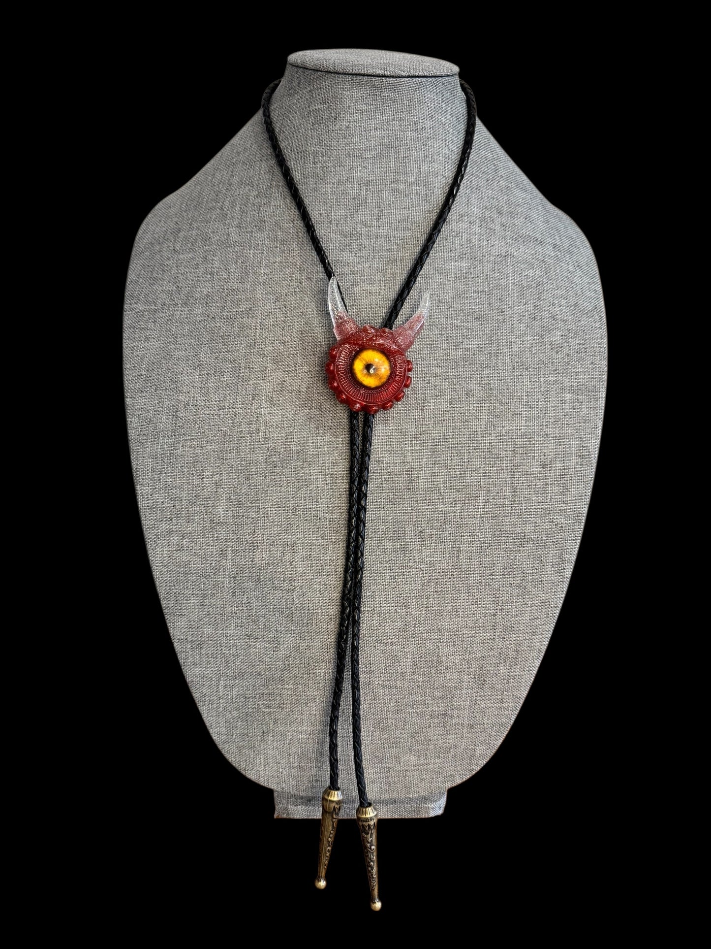 Monster bolo tie in red and silver. Model Vicky.