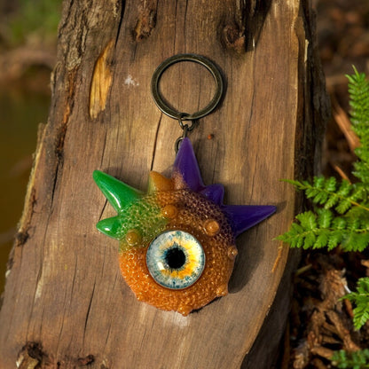 Creepy Monster Eye keychain, Orange, purple and green. Model Spiky.