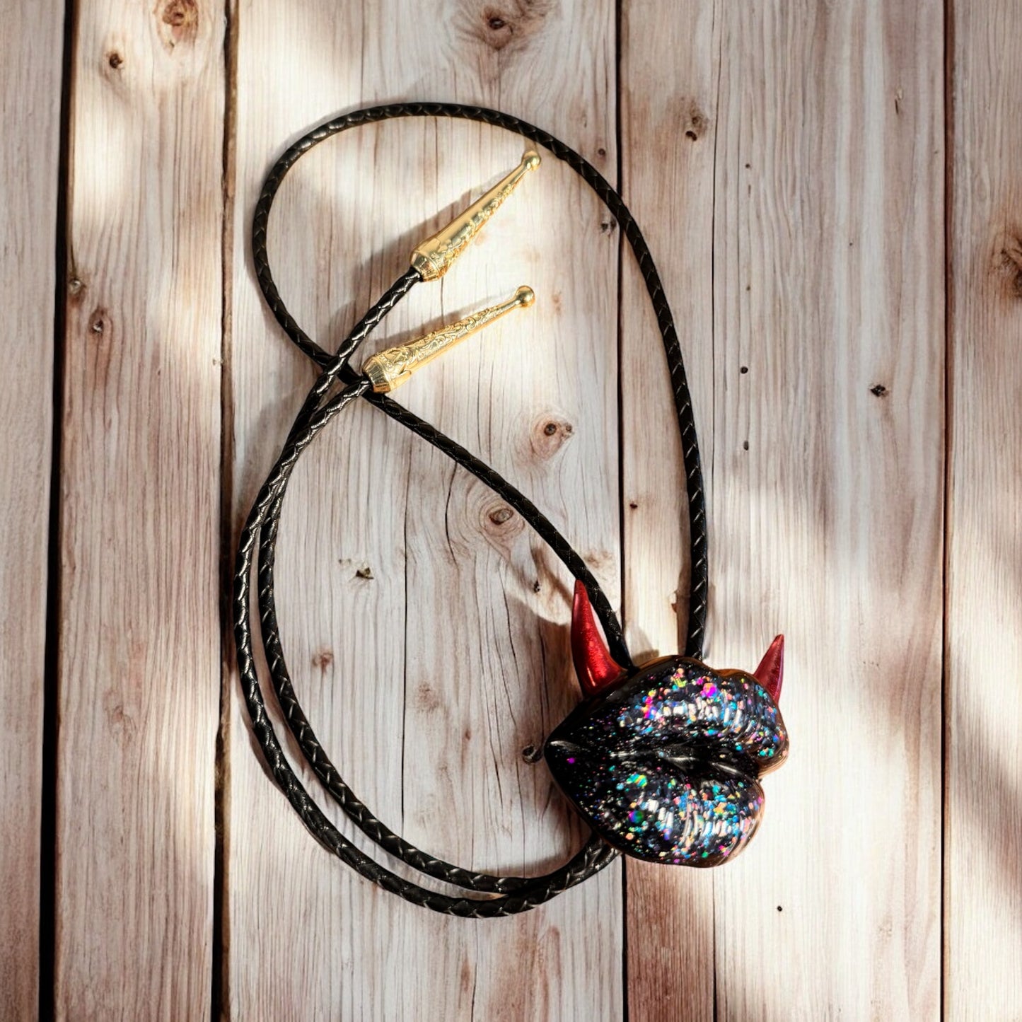 Bolo tie with red horns, shiny black lips