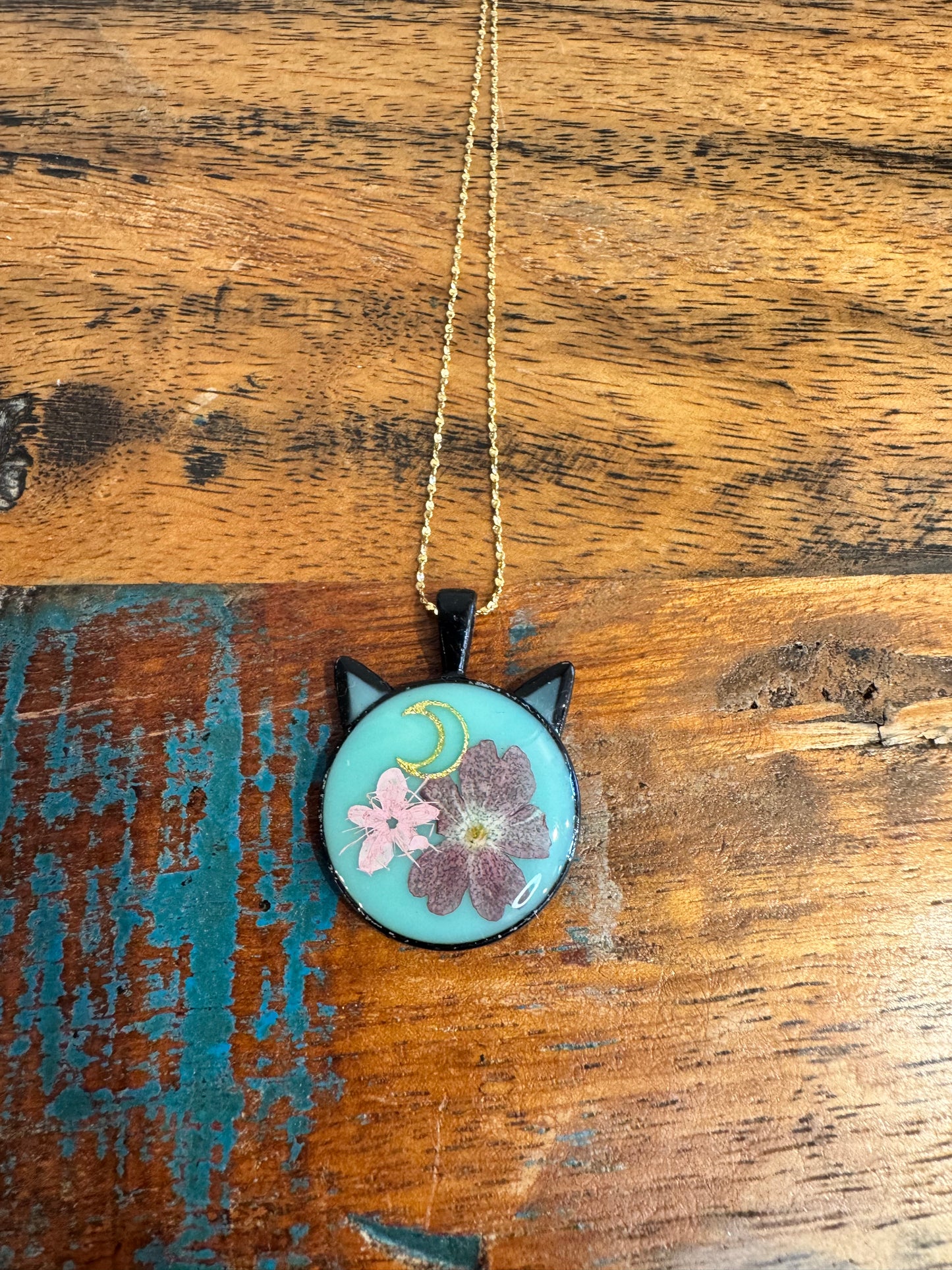 Cat head necklace with pink and purple flowers and moon