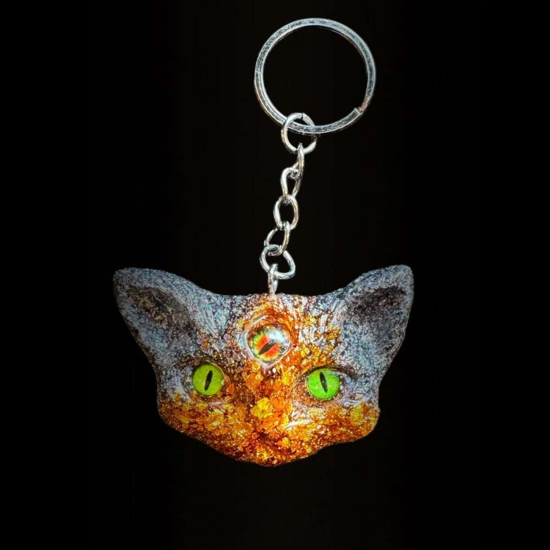 Three eyed cat keychain in orange and black