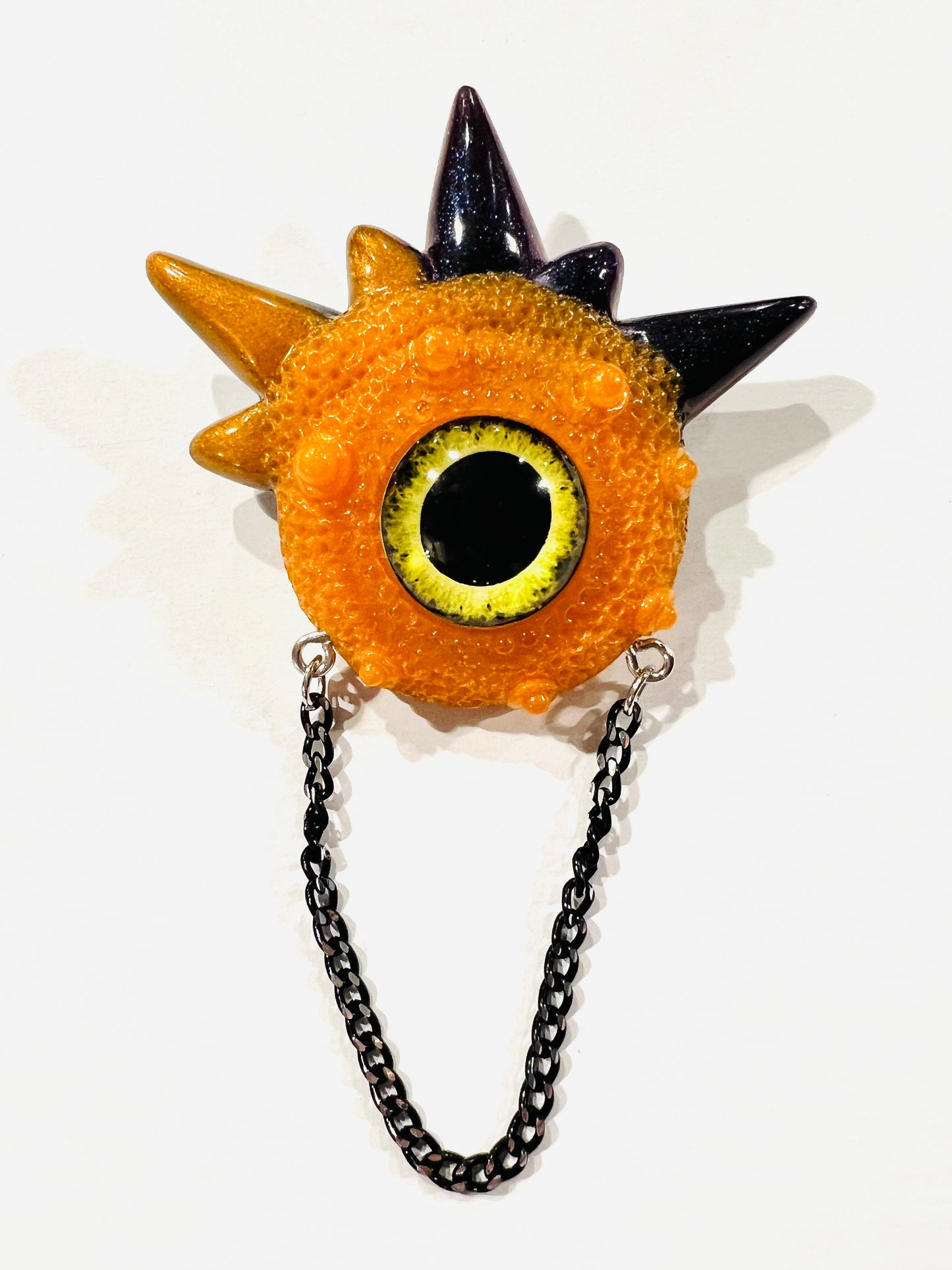 Handmade brooch, orange and black monster brooch, pastel goth jewelry, evil eye brooch in resin,creepy cute,spooky jewelry, kawaii brooch, unique brooch. Model Spiky.