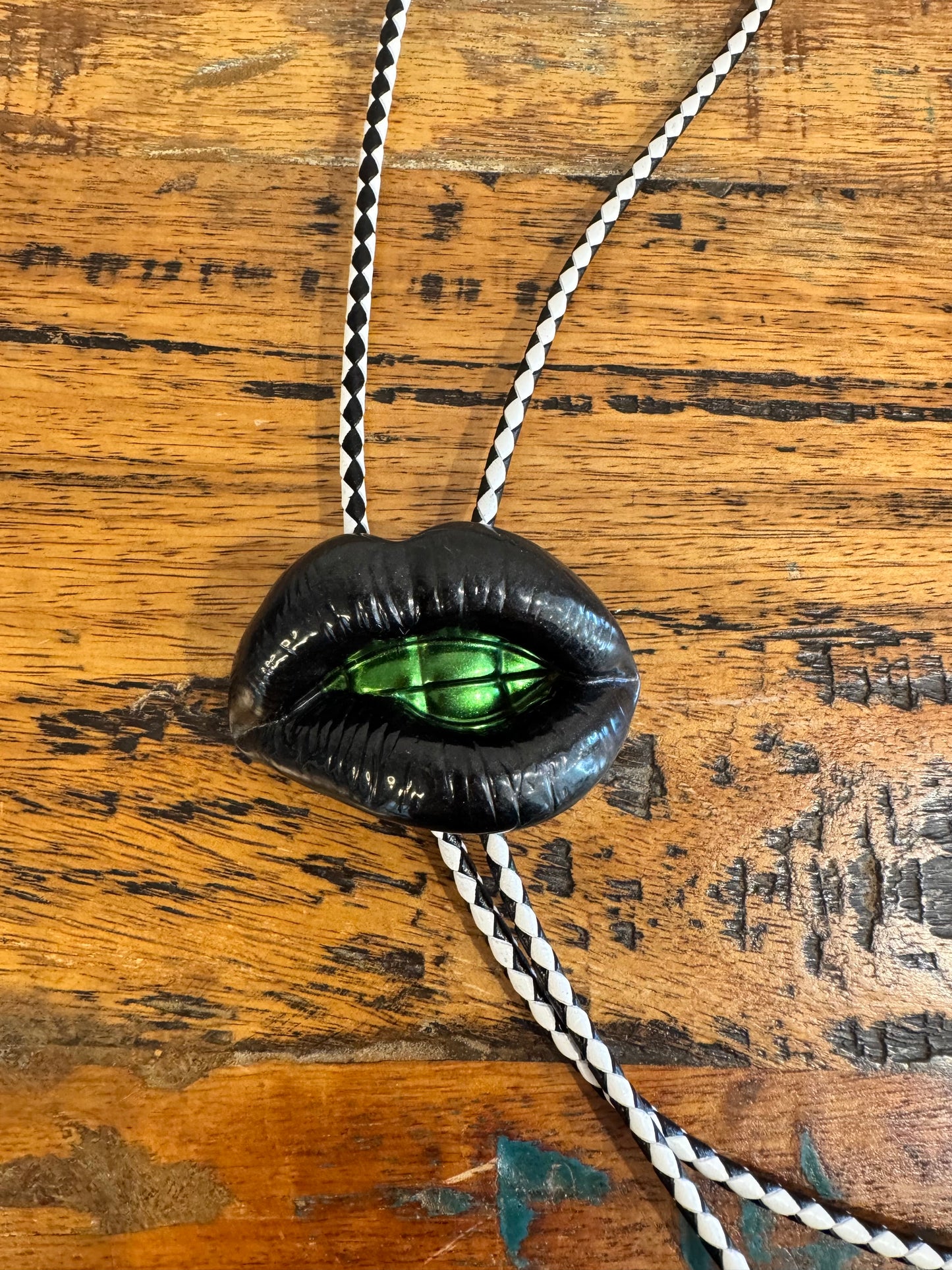 Bolo tie, black lips and green teeth