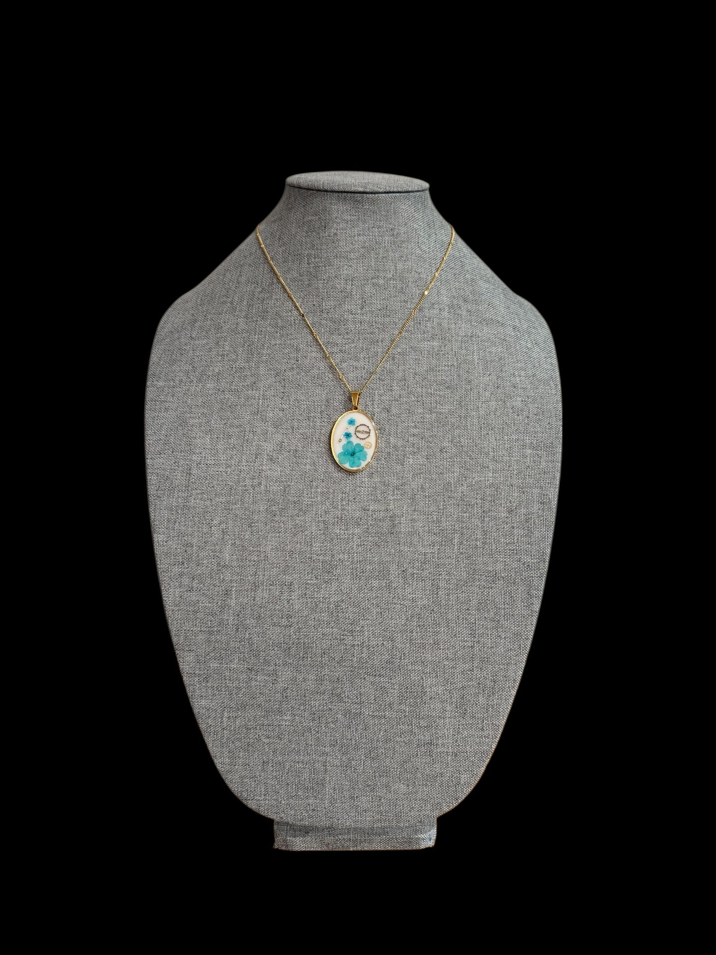 Oval necklace with blue flowers and watch parts