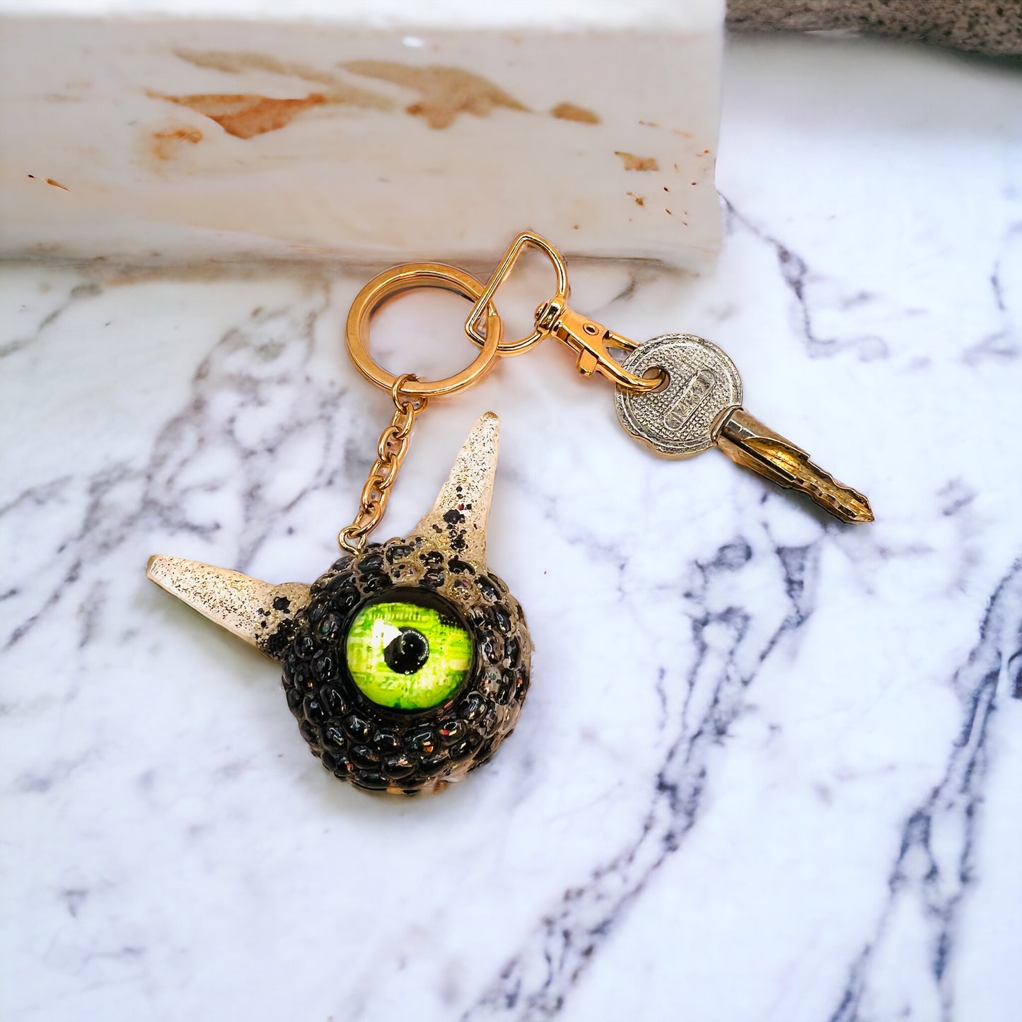 Monster black and gold kawaii keychain. Model Pointy.