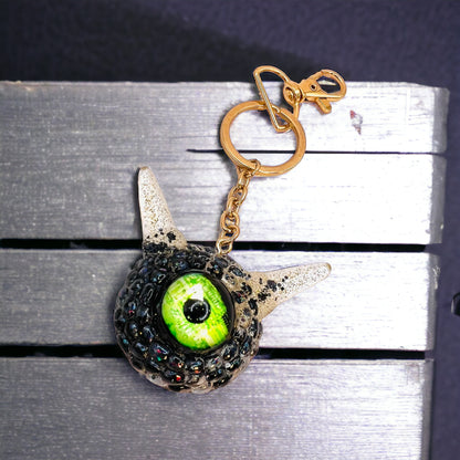 Monster black and gold kawaii keychain. Model Pointy.